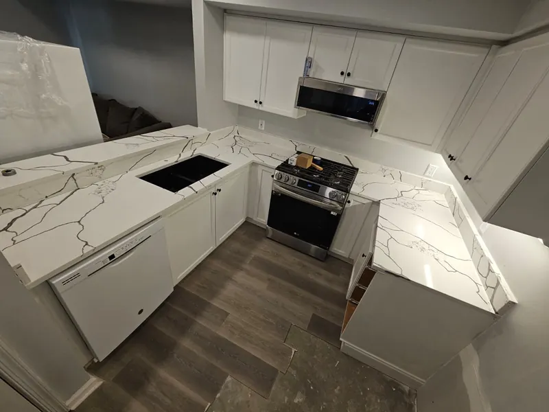 Bold calacatta-look U-shaped kitchen with a black sink – Beltway Countertops, Northern Virginia