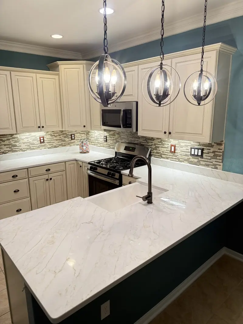 Calacatta gold-look peninsula with a farmhouse sink – Beltway Countertops, Northern Virginia