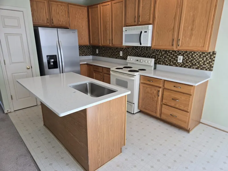 Sparkle white quartz island with oak cabinets – Beltway Countertops, Northern Virginia