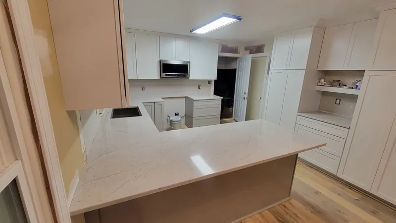 White countertop in a U-shaped kitchen with white cabinets – Beltway Countertops, Northern Virginia