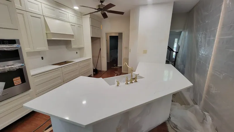 White countertop on an angled island with a farmhouse sink – Beltway Countertops, Northern Virginia